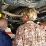 Students working under car